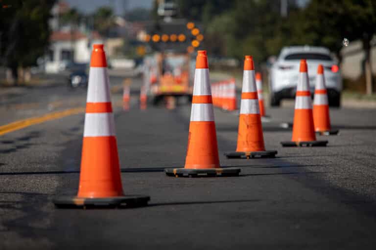 Traffic cones on road with electronic arrow pointing to the righ